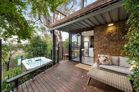 Your secluded deck welcomes you with a spa, outdoor seating, and peaceful garden surrounds.