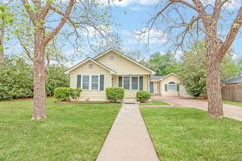 Charming home with manicured landscaping and mature shade trees in a peaceful residential setting