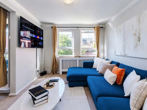 Living Room: Vibrant blue couch with plush pillows invites relaxation and fun conversations!