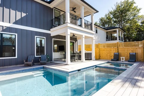 Relax and unwind in your private backyard oasis featuring a heated pool, hot tub, outdoor kitchen with gas grill, and plenty of seating for the whole group ☀️
