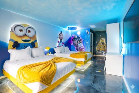 Family-friendly room featuring two beds with minions-themed wall art and vibrant yellow accents.