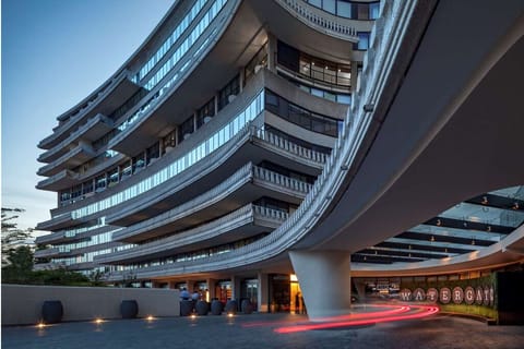 Arrive in style beneath sweeping architecture and elegant evening lights.