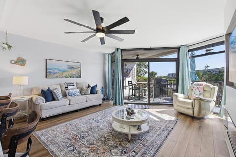 Relax in this bright beach stay retreat featuring a cozy coastal living room, stylish décor, and large sliding doors to a private balcony. Enjoy fresh air, natural light, and the perfect space to unwind after a day at the beach.