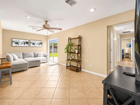 Living Room: Bright and inviting space with a chic sectional and views of the lush backyard!