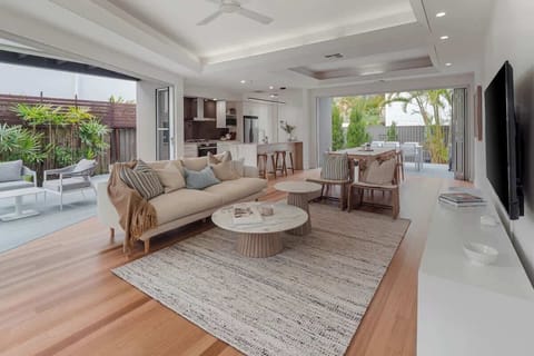 Bright and spacious living space with bifold doors opening up onto the gardens and pool.