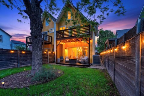 Private backyard oasis with string lights, covered patio, and a glowing evening ambiance perfect for unwinding.