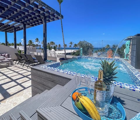 Heated ,jetted hot tub with cascading waterfall over looks the ocean