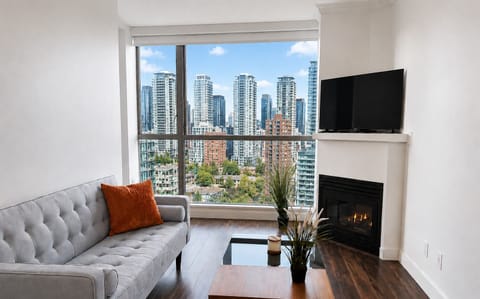 Bright downtown living space with floor to ceiling windows, stunning city views.