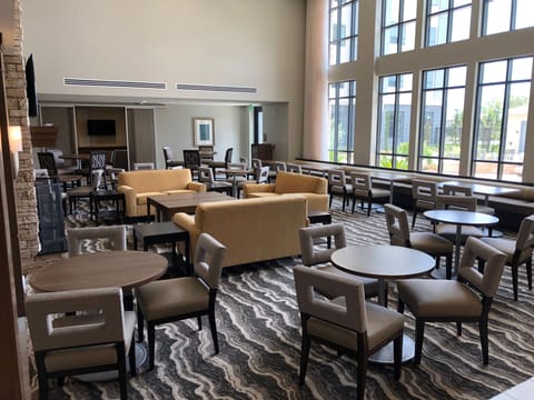 Spacious lounge area with multiple seating options and a fireplace.