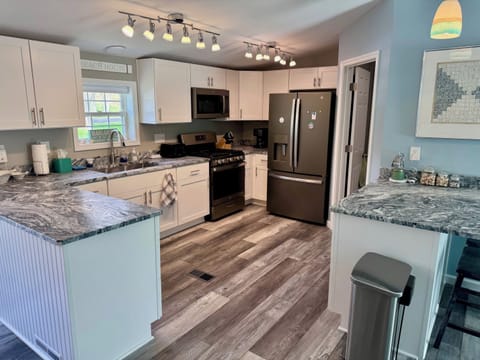 Brand new kitchen fully stocked with gorgeous granite counters & breakfast bar