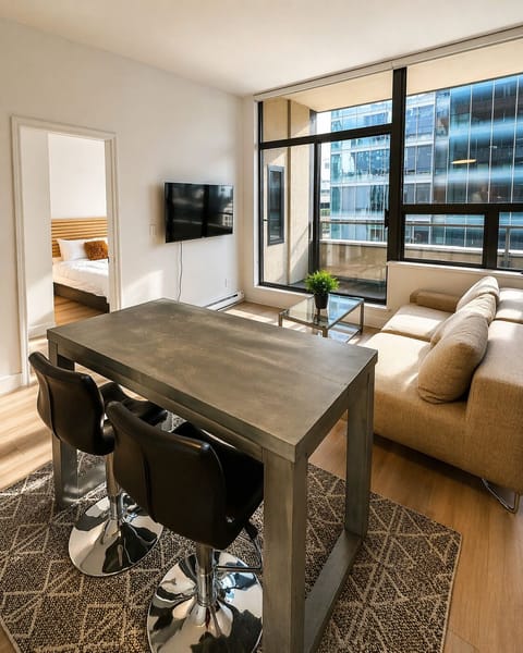Elegant loft living: a polished dining area, lounge seating, balcony access