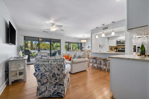 Living area featuring a flatscreen tv, sleeper sofa, and view of golf course