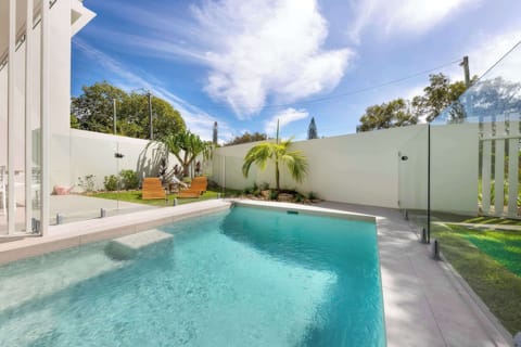 Private saltwater pool surrounded by landscaped tropical gardens