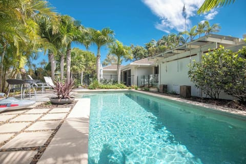 Start your day surrounded by swaying palms and sunshine in this private Noosa oasis.