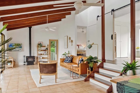 Unwind by the open fireplace in this sunlit living room, designed with warmth and style for slow mornings and relaxed evenings.