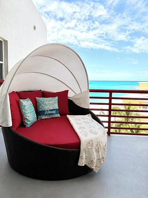 Full size canopy bed at the balcony. Enjoy morning views, afternoon naps, sunset