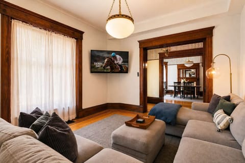 Living Room: Bright and airy living room featuring large windows that fill the space with natural light. Enjoy a comfortable setup perfect for relaxing, reading, or unwinding in a warm and inviting atmosphere.
