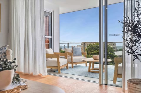 Seamless indoor outdoor flow leading to a breezy private balcony.