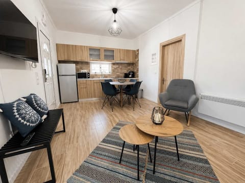 The open-plan living and kitchen area is bright and functional, with comfortable seating and a dining space that makes it easy to relax or share meals indoors.