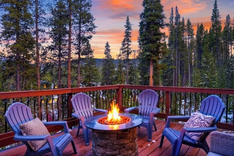 Fire pit deck with Adirondack seating and stunning sunset views over the forest.