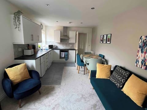 Spacious, comfortable living room with dining area and kitchen.