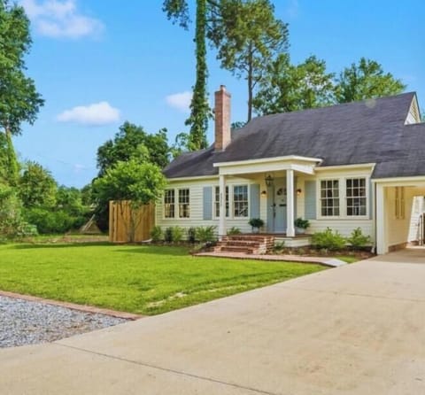 Welcome to Southern Cypress Retreat - this charming home features a spacious front lawn and inviting curb appeal, perfect for a relaxing stay.