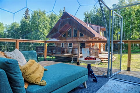 Inside the heated dome looking out at Aurora. Your private log cabin retreat. 