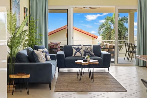 Bright living room with comfortable seating and direct access to a private terrace for indoor-outdoor living