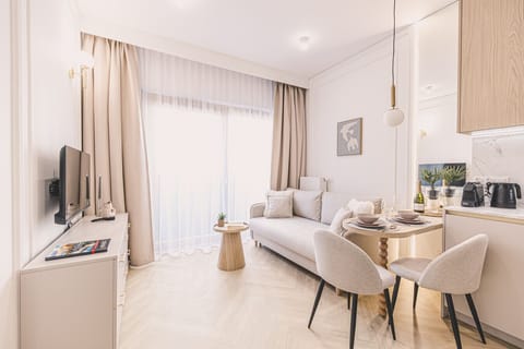 Stylish living room with kitchen and dining area in a new apartment close to Opera Nova and the city center attractions.