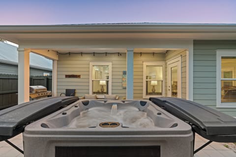Relax in the private hot tub on the covered patio, complete with outdoor seating and grill for easy evenings in.
