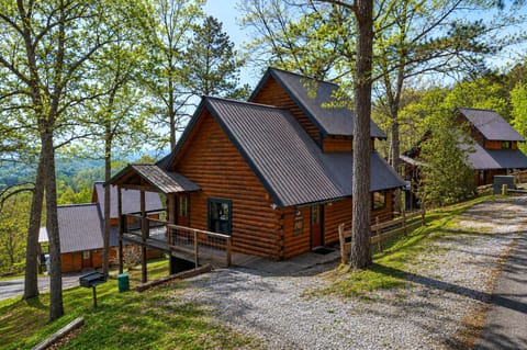 Hillside log cabins tucked among the trees, offering a quiet mountain escape with sweeping valley views.