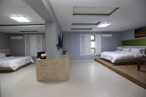 Deluxe Family Room | Premium bedding, desk, iron/ironing board, free WiFi