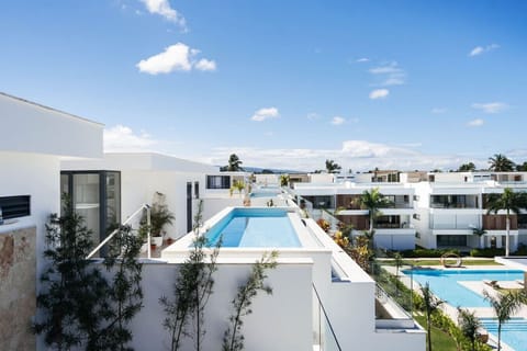 Private rooftop pool with open sky views—plus access to a larger shared pool below. Bright, modern space in a quiet, resort-style community.