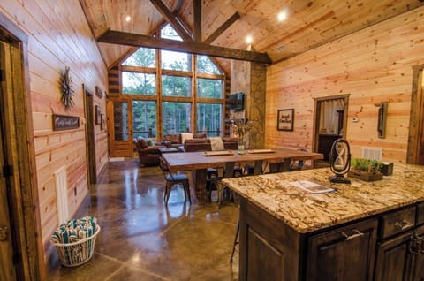 Stunning open-concept living with soaring windows and forest views