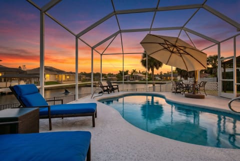Sun melting into the horizon, warm water lapping the canal, your toes in the pool. This is the view from your private screened lanai. Canal-front Palm Coast home near Flagler Beach. Dolphins not guaranteed — but they do show up.