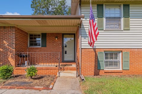 Welcome to Shady Grove Cottage! This exterior entrance shows a few easy steps leading to the front door, offering a simple and convenient arrival experience.