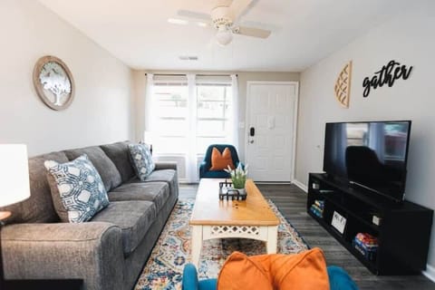 The living room centers around a large smart television, creating an easy spot to relax, stream your favorites, and unwind after a full day.