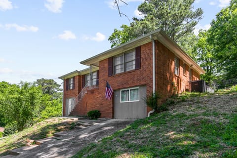 Welcome to Broadmoor Brick Haven—easy driveway access leads you right in, with the lower-level entrance to Unit B clearly visible at the front and Unit A's entrance in the back.