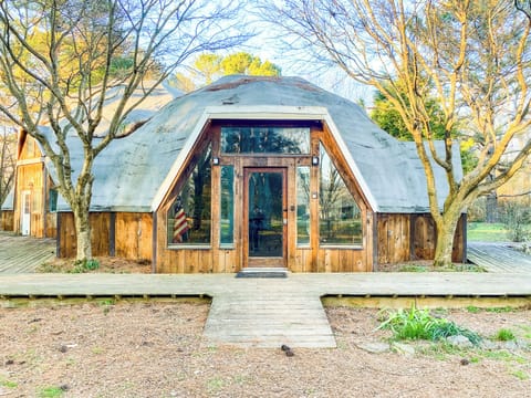 Welcome to the Dome House on Bell! This unique, dome-style exterior is set among beautiful trees and natural surroundings, creating a quiet and relaxing retreat.