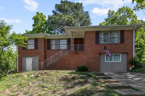 Welcome to Broadmoor Brick Haven—easy driveway access leads you right in, with the lower-level entrance to Unit B clearly visible at the front.