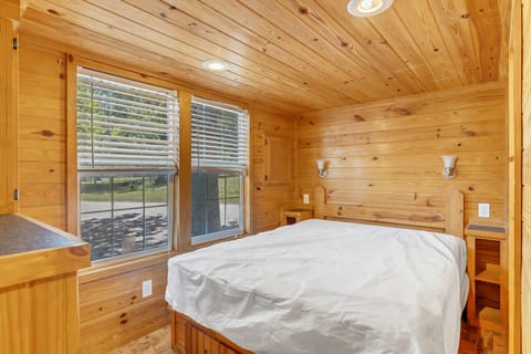 Drift off in a bright bedroom with calming wooded views.