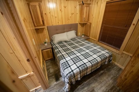 Unwind in a cozy queen bed after lakeside adventures.