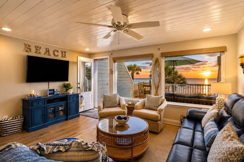 Sun-drenched living room with panoramic ocean views and comfortable seating.