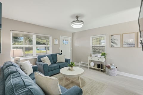 Settle into a light-filled living space designed for comfort and connection, where cozy seating and coastal touches invite you to relax after a day at the beach. Perfect for slow mornings, movie nights, and easy, relaxing stays.