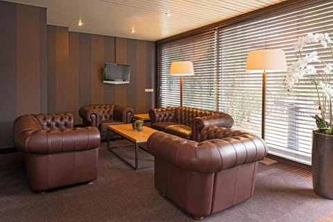 Unwind on plush leather sofas beside warm, glowing lamps.