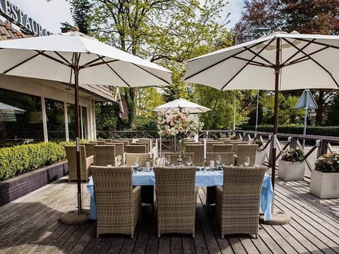 Savor sunny afternoons with elegant al fresco dining under umbrellas.