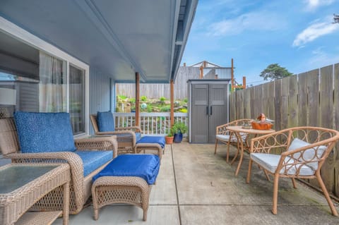 Unwind on your private covered patio with comfy wicker seating and dining space, perfect for morning coffee or evening relaxation.