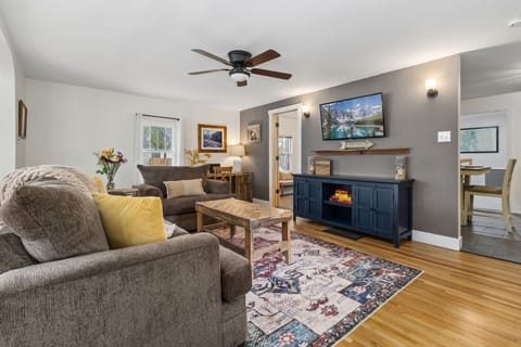 Living Room with 55" Smart TV and Laptop-friendly Workspace