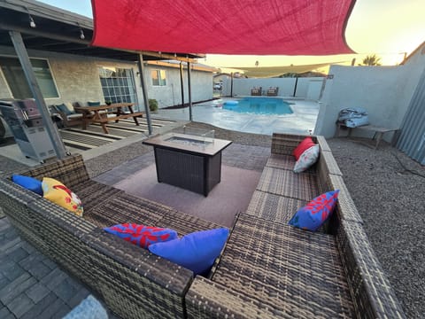 back yardfireplace, handrail, summer, terrace patio, grill, outdoor, dining table, pool visible