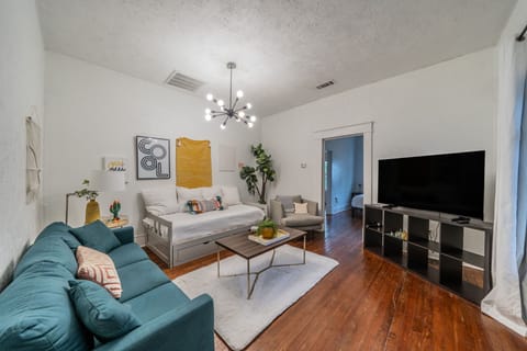 Stylish living room with a cozy sofa and large flat-screen TV.
